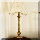 DL03. One of a pair of gold tone table lamps with beaded shades. 